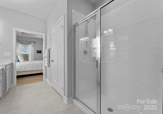 full bathroom featuring tile patterned floors, a shower stall, vanity, and ensuite bathroom