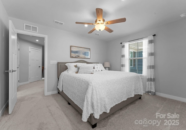 bedroom with light colored carpet, visible vents, and baseboards