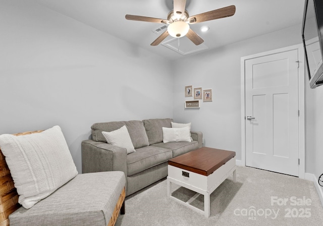 living area with light carpet, a ceiling fan, and baseboards