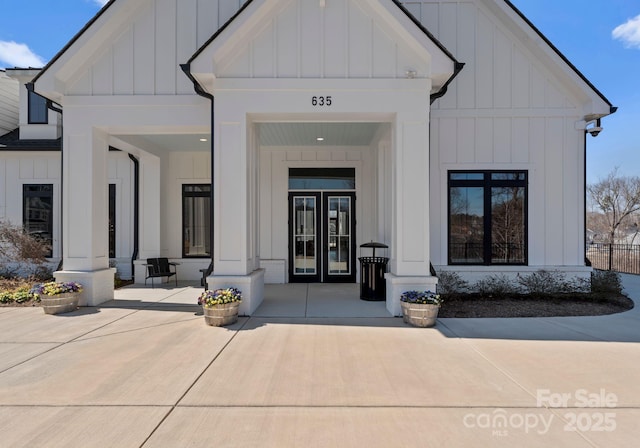 property entrance with french doors and board and batten siding