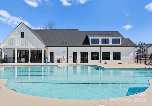 community pool featuring fence and a patio