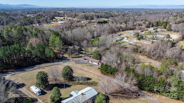 birds eye view of property featuring a view of trees