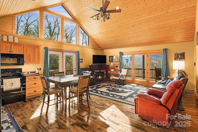 dining area with a warm lit fireplace, french doors, wooden ceiling, and dark wood finished floors