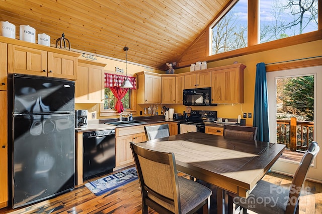 kitchen with light wood-style flooring, wood ceiling, light brown cabinets, a sink, and black appliances