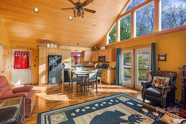 dining room featuring ceiling fan, french doors, light wood finished floors, and wooden ceiling