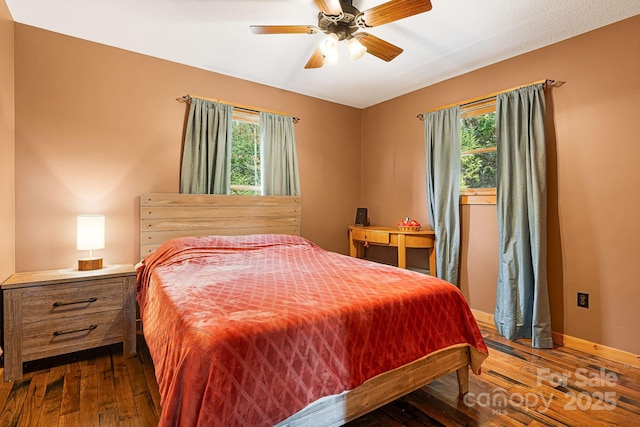 bedroom featuring wood-type flooring, baseboards, and a ceiling fan