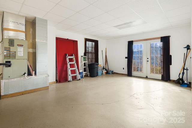 garage with baseboards and french doors