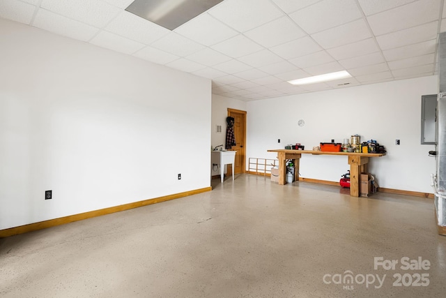 parking garage with baseboards and a sink