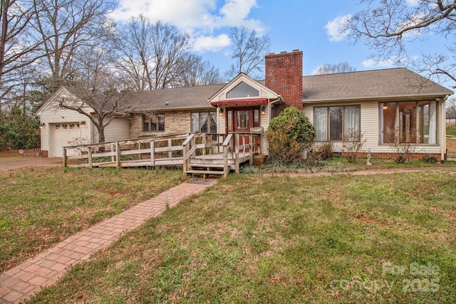 ranch-style house with driveway, a chimney, an attached garage, a wooden deck, and a front yard