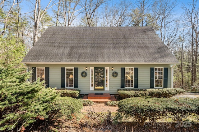 cape cod house featuring a shingled roof