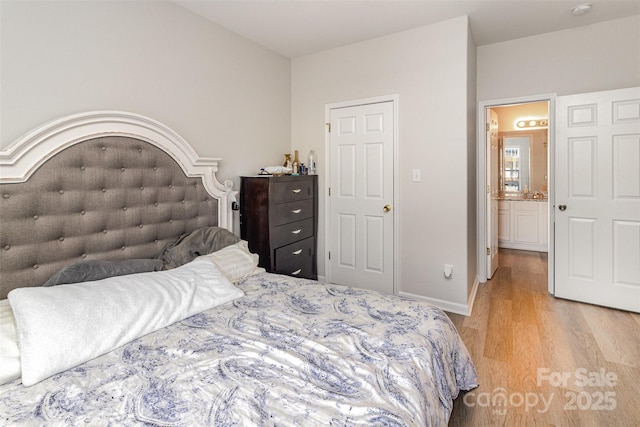 bedroom featuring light wood-type flooring and baseboards