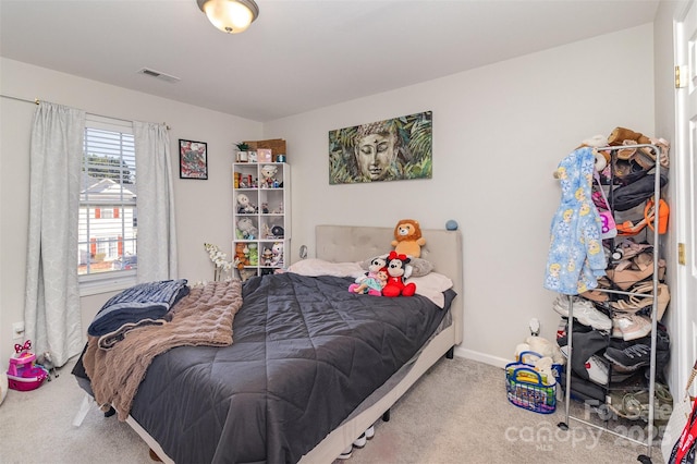 bedroom with carpet flooring, visible vents, and baseboards