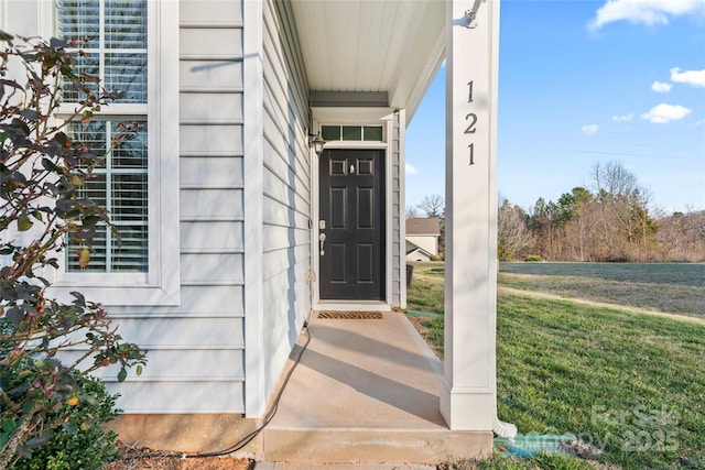 doorway to property with a yard