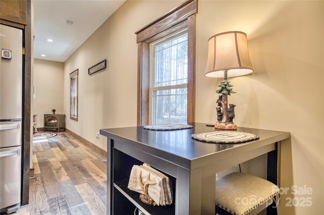 corridor featuring recessed lighting, baseboards, and wood finished floors