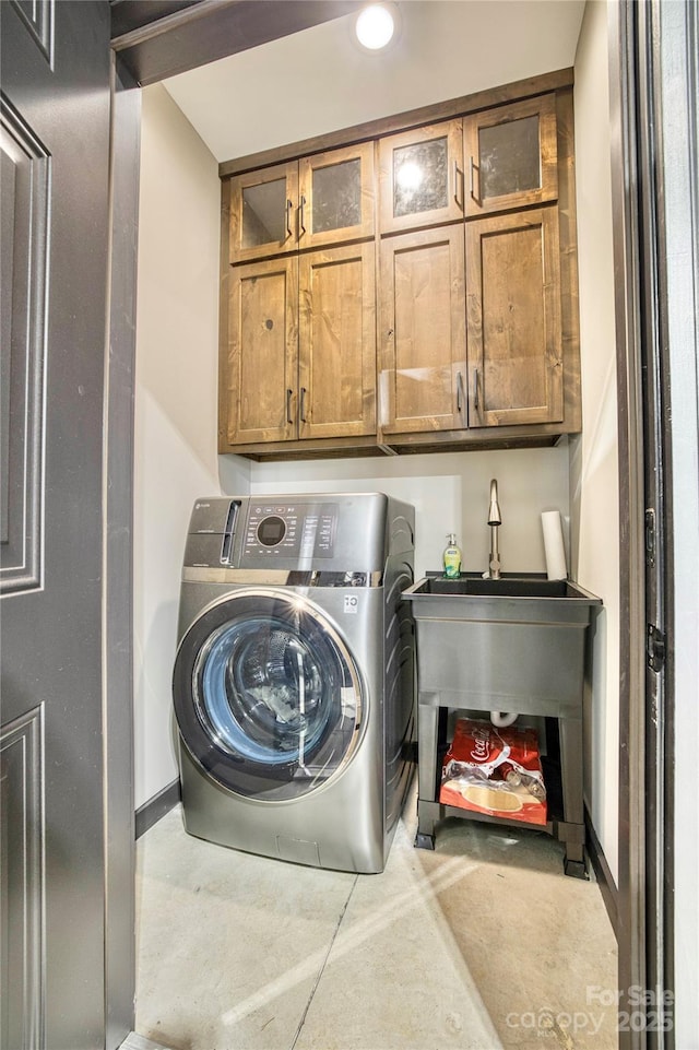 laundry area featuring washer / dryer and cabinet space