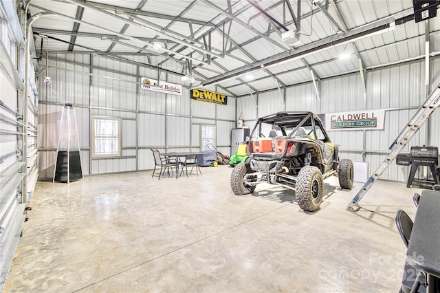 garage with a garage door opener, water heater, and metal wall