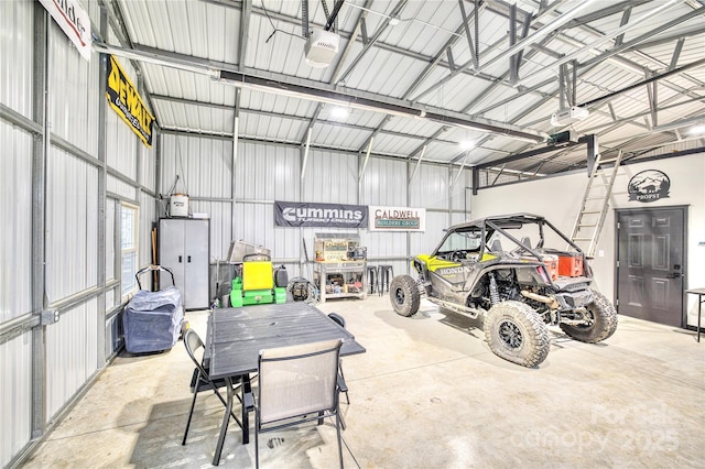 garage with metal wall and a garage door opener