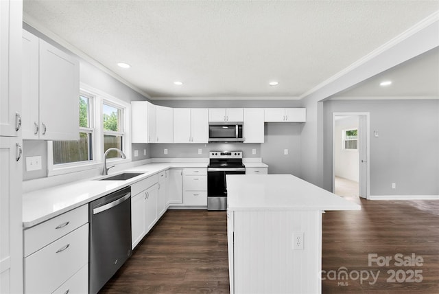 228 Tot Dellinger Rd, Cherryville, NC 28021 - kitchen with stainless steel appliances, a sink, crown molding, dark wood-type flooring, and a kitchen island