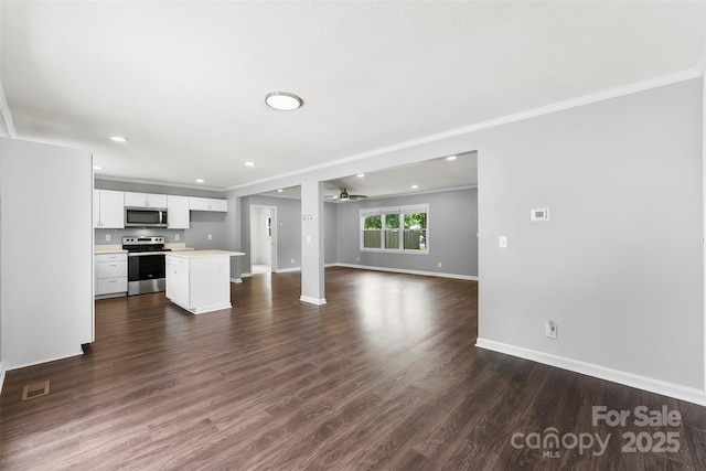 228 Tot Dellinger Rd, Cherryville, NC 28021 - unfurnished living room with baseboards, crown molding, ceiling fan, dark wood finished floors, and recessed lighting