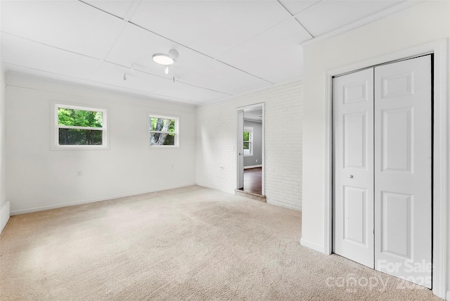228 Tot Dellinger Rd, Cherryville, NC 28021 - unfurnished bedroom with carpet flooring, multiple windows, brick wall, and a closet
