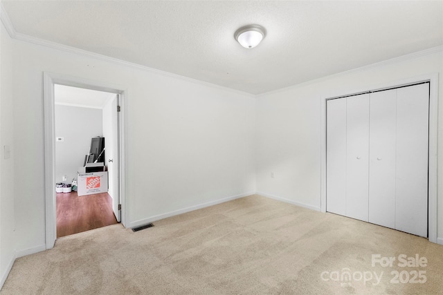 228 Tot Dellinger Rd, Cherryville, NC 28021 - unfurnished bedroom with crown molding, carpet, baseboards, and a closet