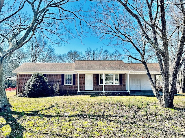 single story home with a front lawn and brick siding