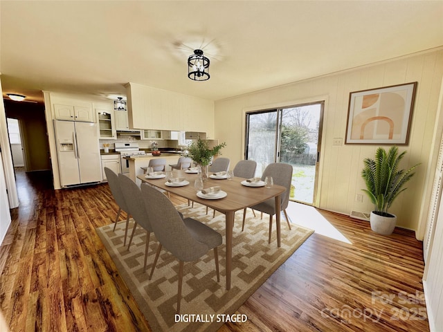 dining area with dark wood-style floors and visible vents