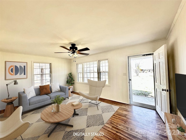 living room with ceiling fan, wood finished floors, and a wealth of natural light