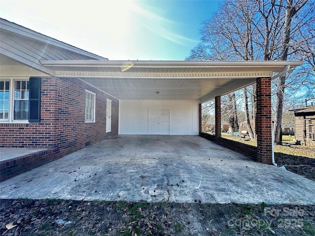 exterior space featuring an attached carport and concrete driveway