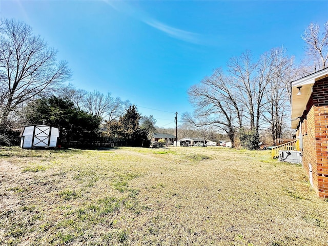 view of yard with an outdoor structure and a storage unit