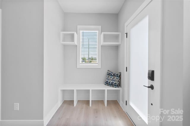 mudroom featuring wood finished floors and baseboards