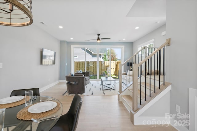 dining space with recessed lighting, wood finished floors, visible vents, and stairs