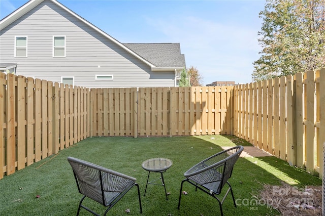 view of yard with an outdoor fire pit and a fenced backyard