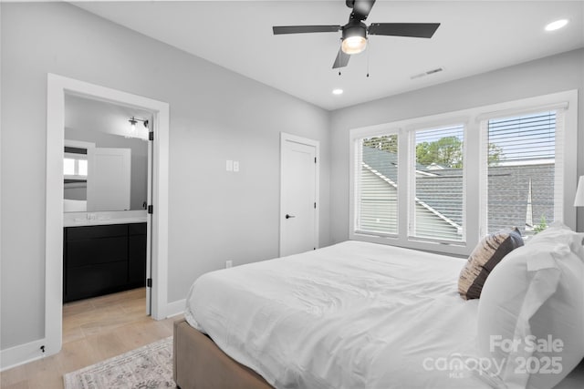 bedroom featuring light wood finished floors, recessed lighting, visible vents, connected bathroom, and baseboards