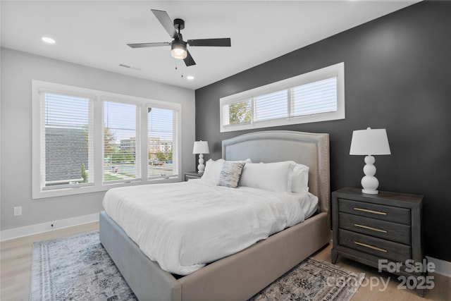 bedroom with recessed lighting, visible vents, light wood finished floors, and baseboards