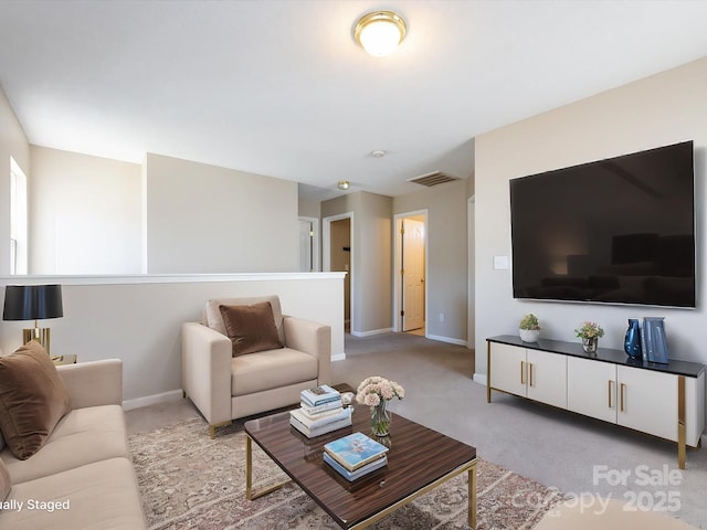 living room with carpet, visible vents, and baseboards