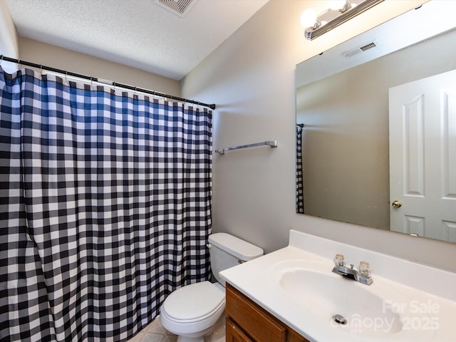 bathroom with visible vents, a textured ceiling, toilet, and vanity