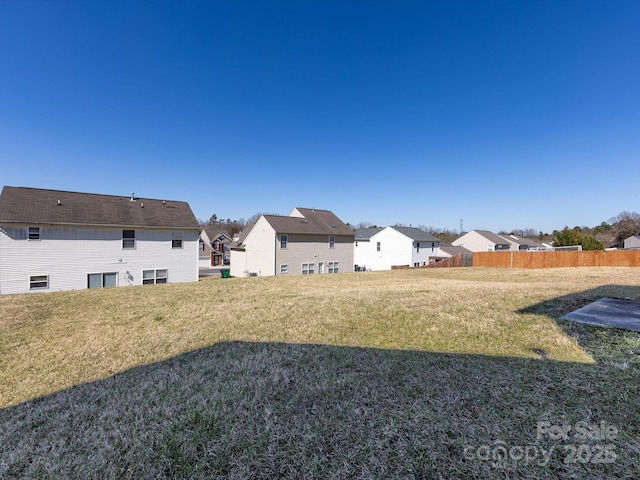 view of yard featuring a residential view and fence