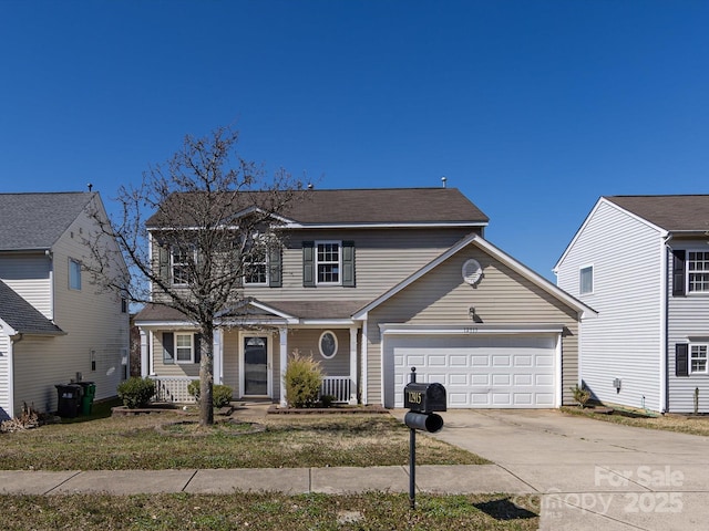 traditional-style house with a garage, driveway, central AC, and covered porch