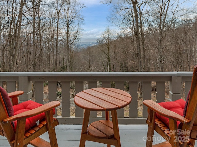 wooden terrace with a view of trees