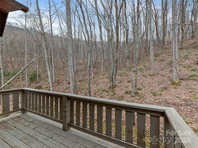 wooden deck featuring a view of trees