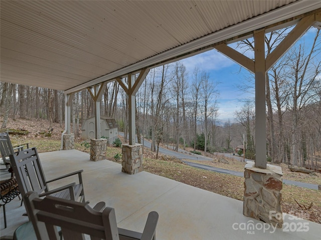 view of patio featuring a storage shed and an outdoor structure