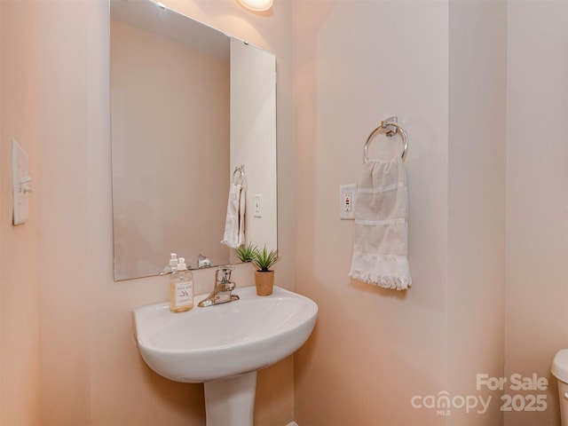 bathroom with toilet and a sink