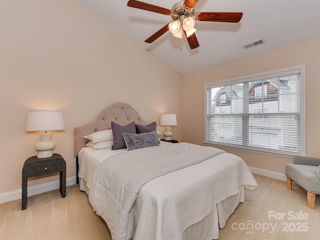 bedroom featuring light colored carpet, vaulted ceiling, visible vents, and baseboards