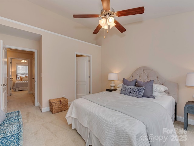 bedroom featuring light carpet, ceiling fan, and baseboards