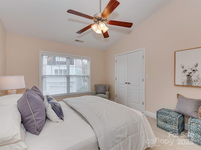 bedroom featuring lofted ceiling, visible vents, light carpet, ceiling fan, and baseboards