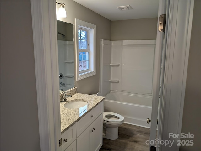 bathroom with shower / bath combination, visible vents, toilet, and vanity