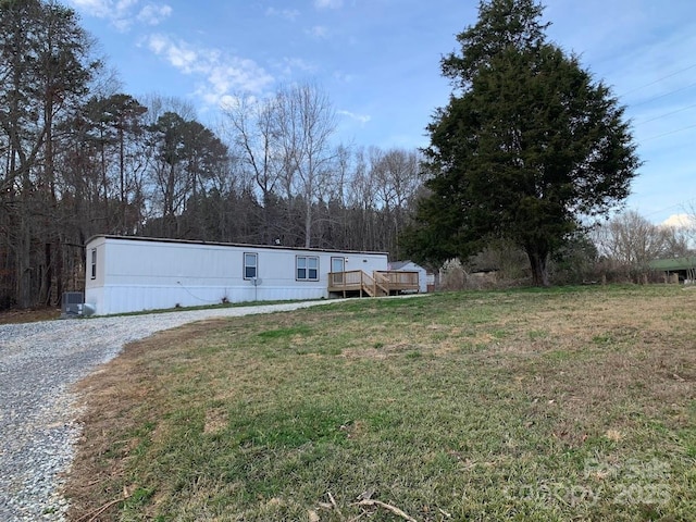 view of front facade featuring a deck and a front lawn