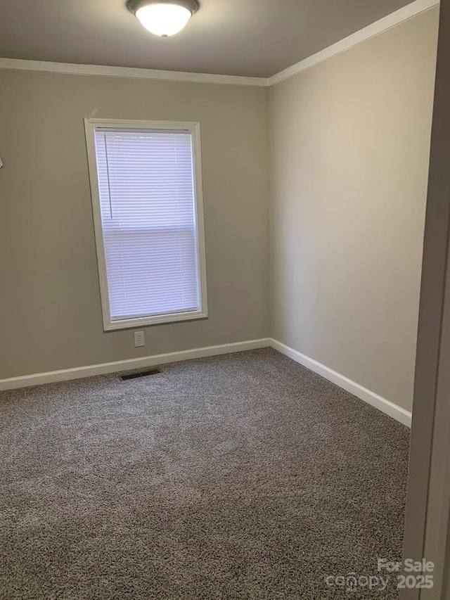 empty room featuring visible vents, ornamental molding, and carpet flooring