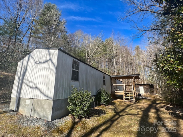 view of property exterior featuring a wooden deck